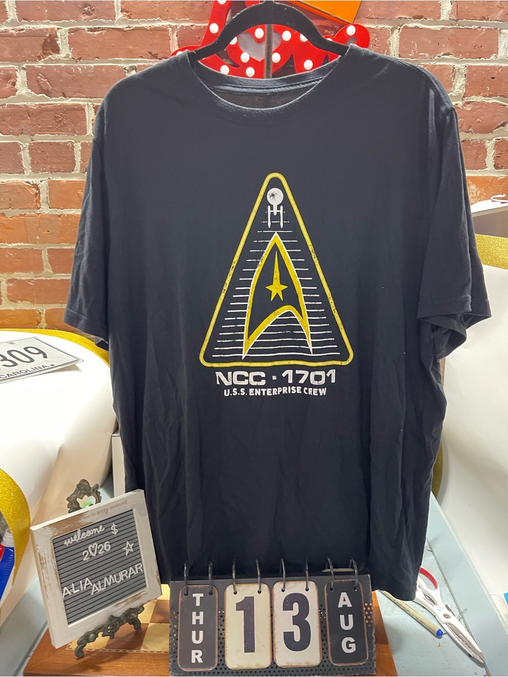 black Star Trek collegiate-style graphic tee features a distressed U.S.S. Enterp